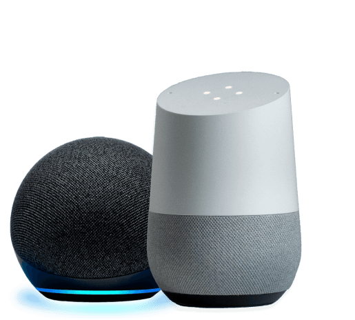 An Amazon Echo smart speaker, charcoal in color, spherical in shape with a blue light ring; Google Home smart speaker with a white and gray cylindrical design.